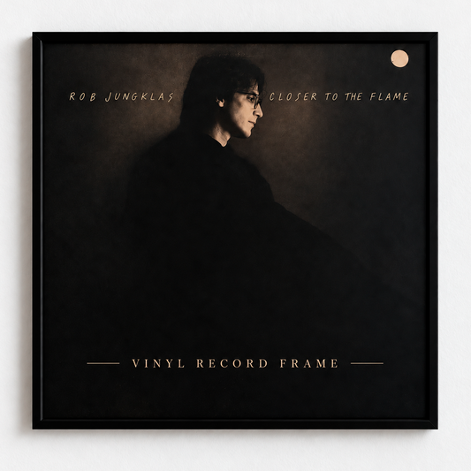 Black 12" vinyl record frame on a white wall with an album cover inside — front view