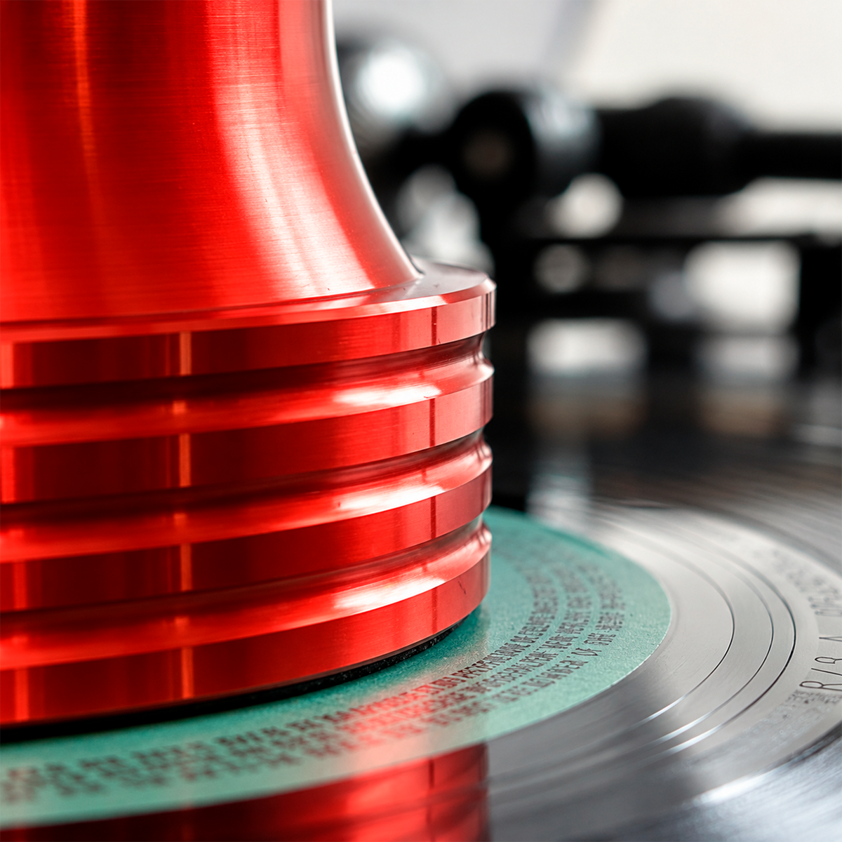 Close-up of the Red Vinyl Record Stabilizer on a spinning record