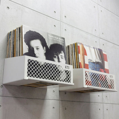 Flying V x8 wall mounted vinyl display in white on a brick gallery wall