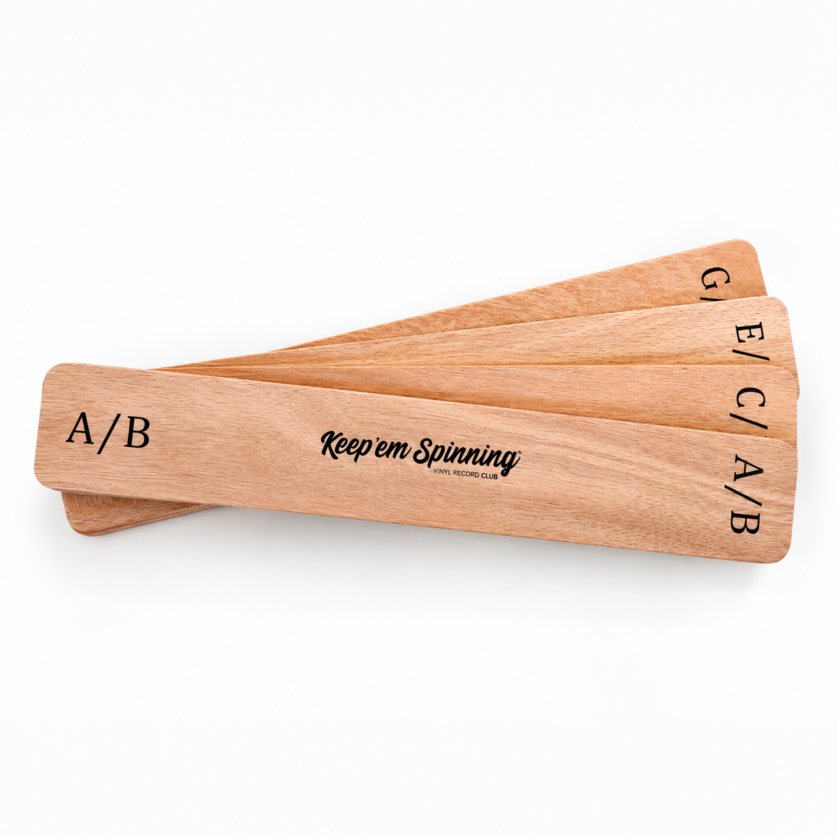 Plywood vinyl record dividers fanned out — A/B, C/D, E/F and G/H letter pairs with Keep 'em Spinning logo