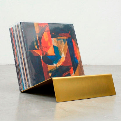 Gold powder-coated Vinyl Break record stand holding LP collection upright on concrete floor