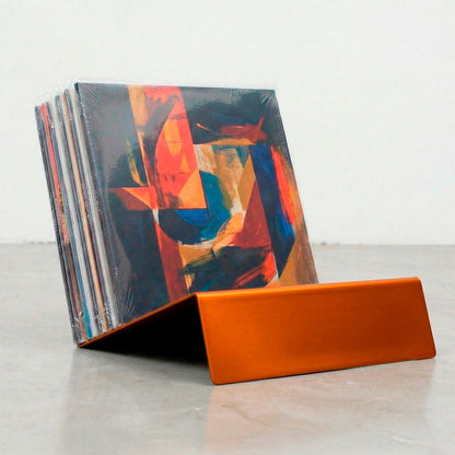 Orange Vinyl Break minimalist steel LP stand displaying vinyl record collection upright