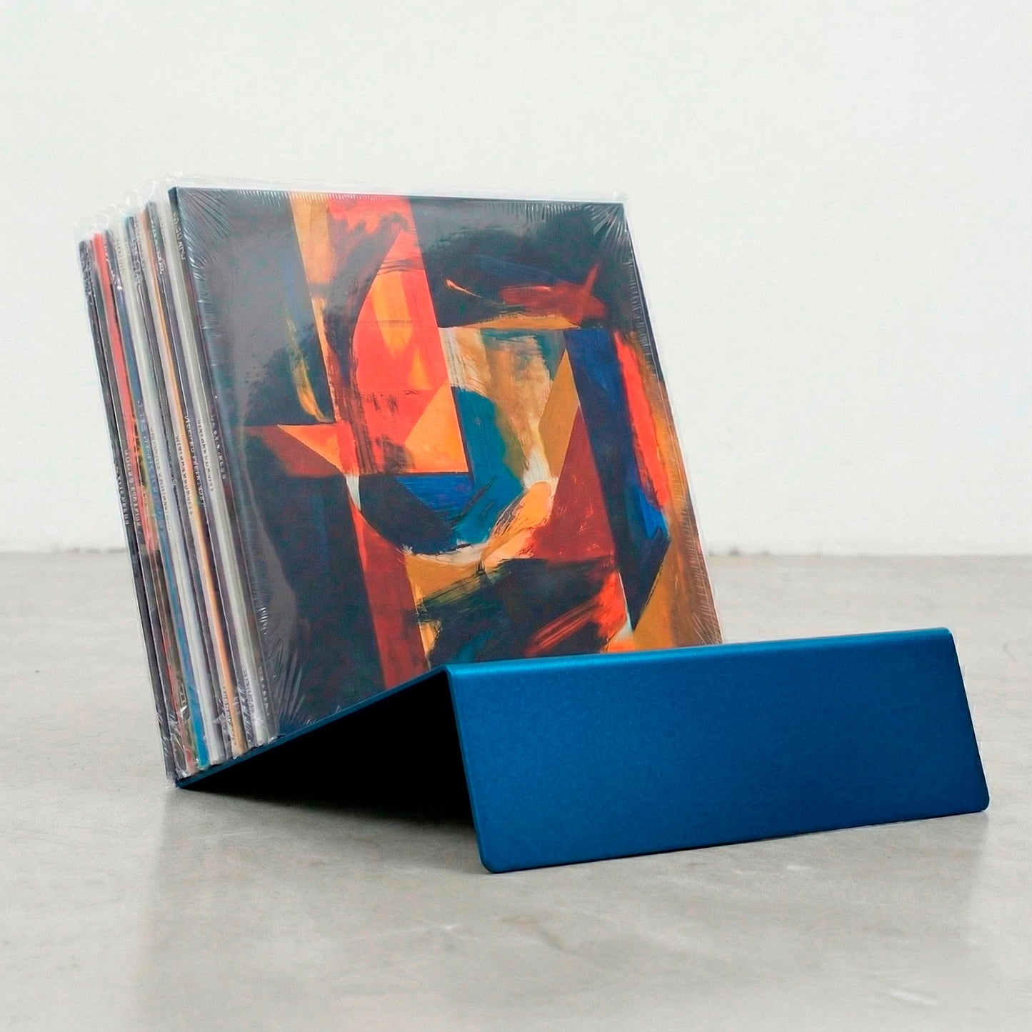 Blue powder-coated Vinyl Break steel record display stand with vinyl LP collection