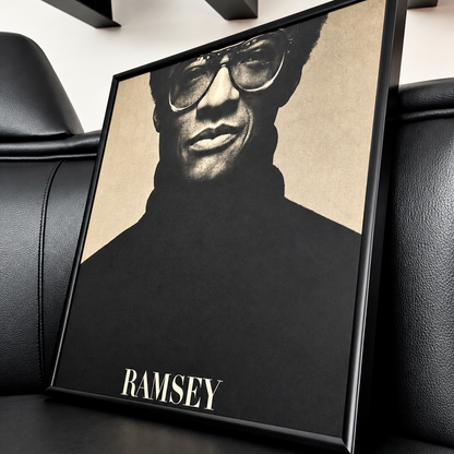 Black 12" vinyl record frame with an album cover, leaning on a leather sofa