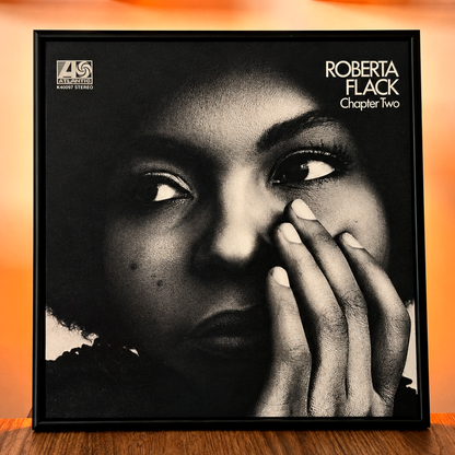 Close-up front view of the black 12" vinyl record frame with an album cover