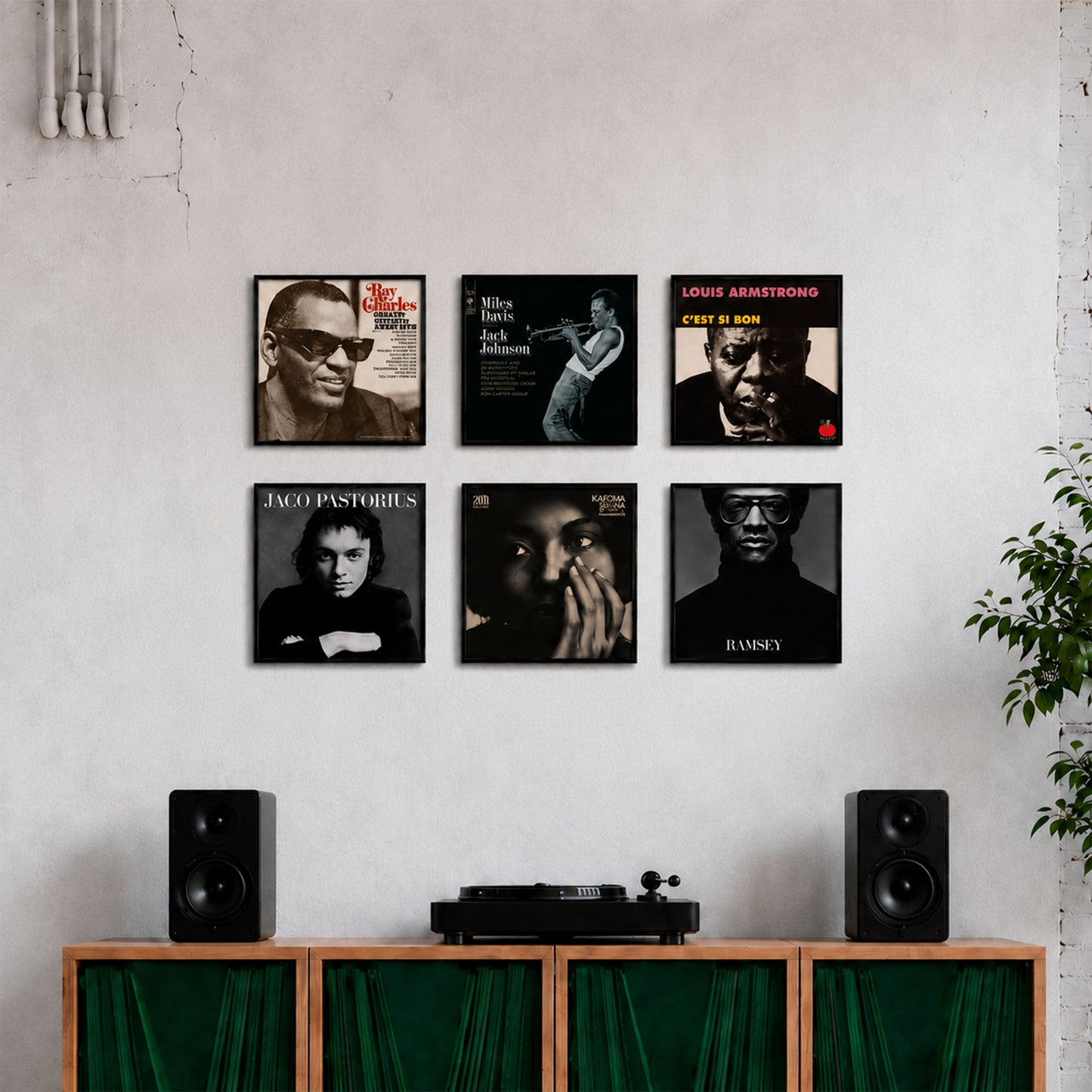 Multiple 12-inch vinyl record frames displaying album covers on a wall above a turntable and speakers — Keep Them Spinning